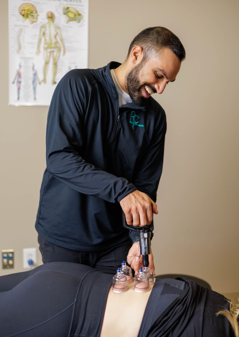 Dr. Surani performing cupping therapy on patients back.