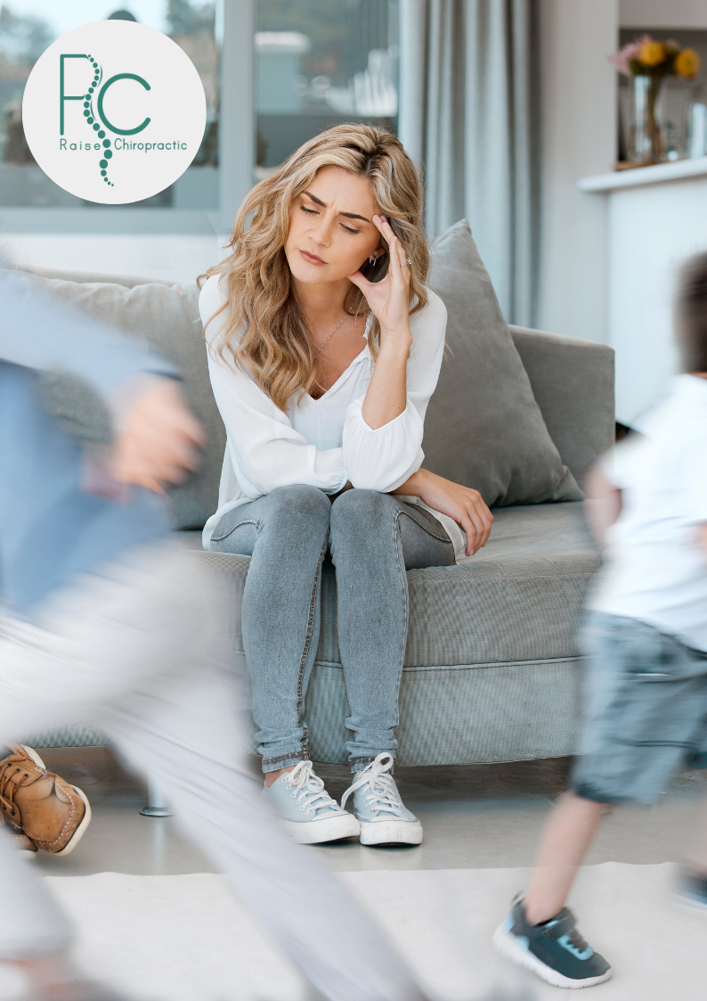 mom sitting on the couch stressed with life.