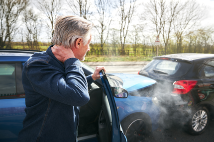 A man feeling whiplash symptoms after being in a minor car accident in Littleton, CO.