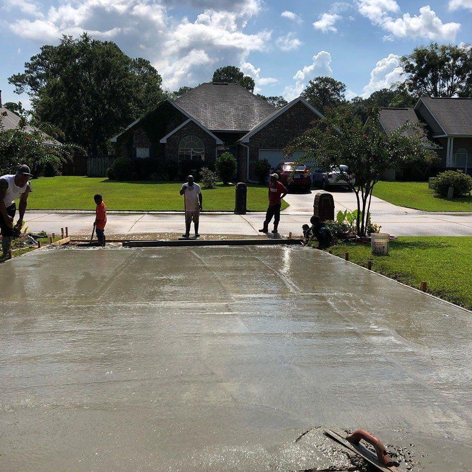 Worker Smoothing Concrete on A New Driveway — Biloxi, MS — C. Mason Concrete