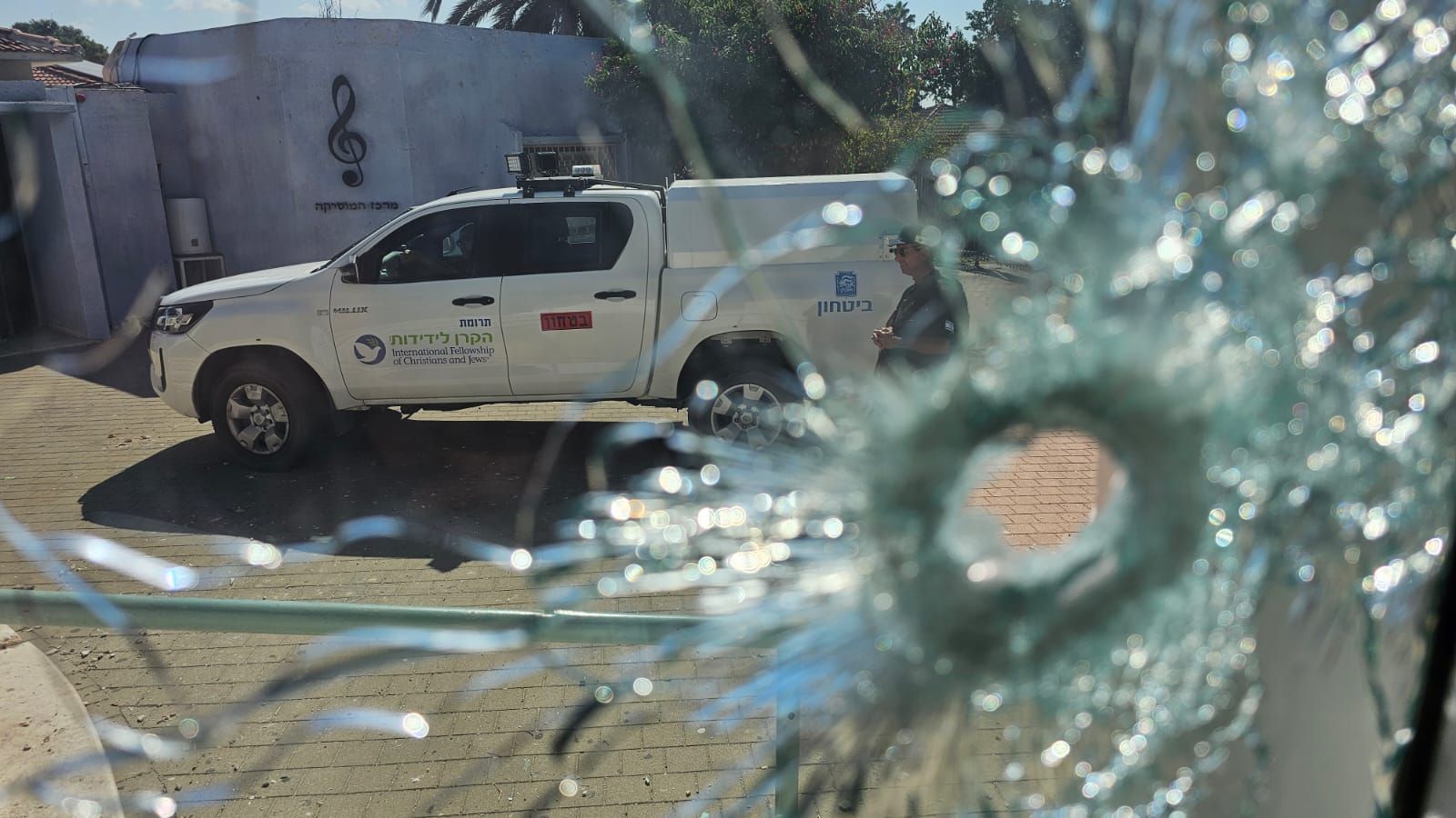 A white truck is parked in front of a building.