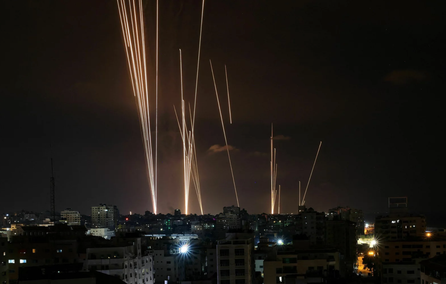 Fireworks are lit up in the night sky over a city
