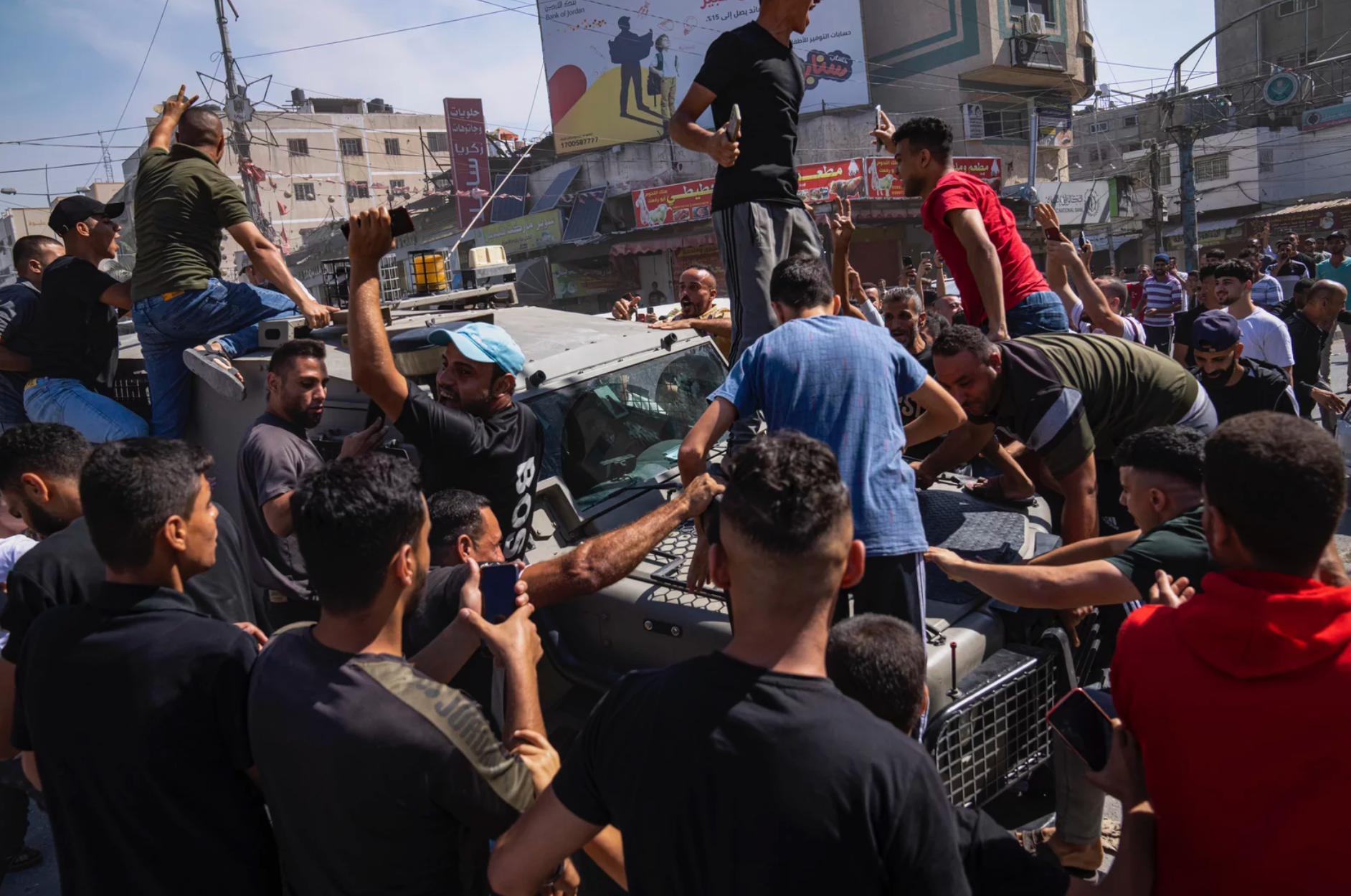 A group of people are standing on top of a car.