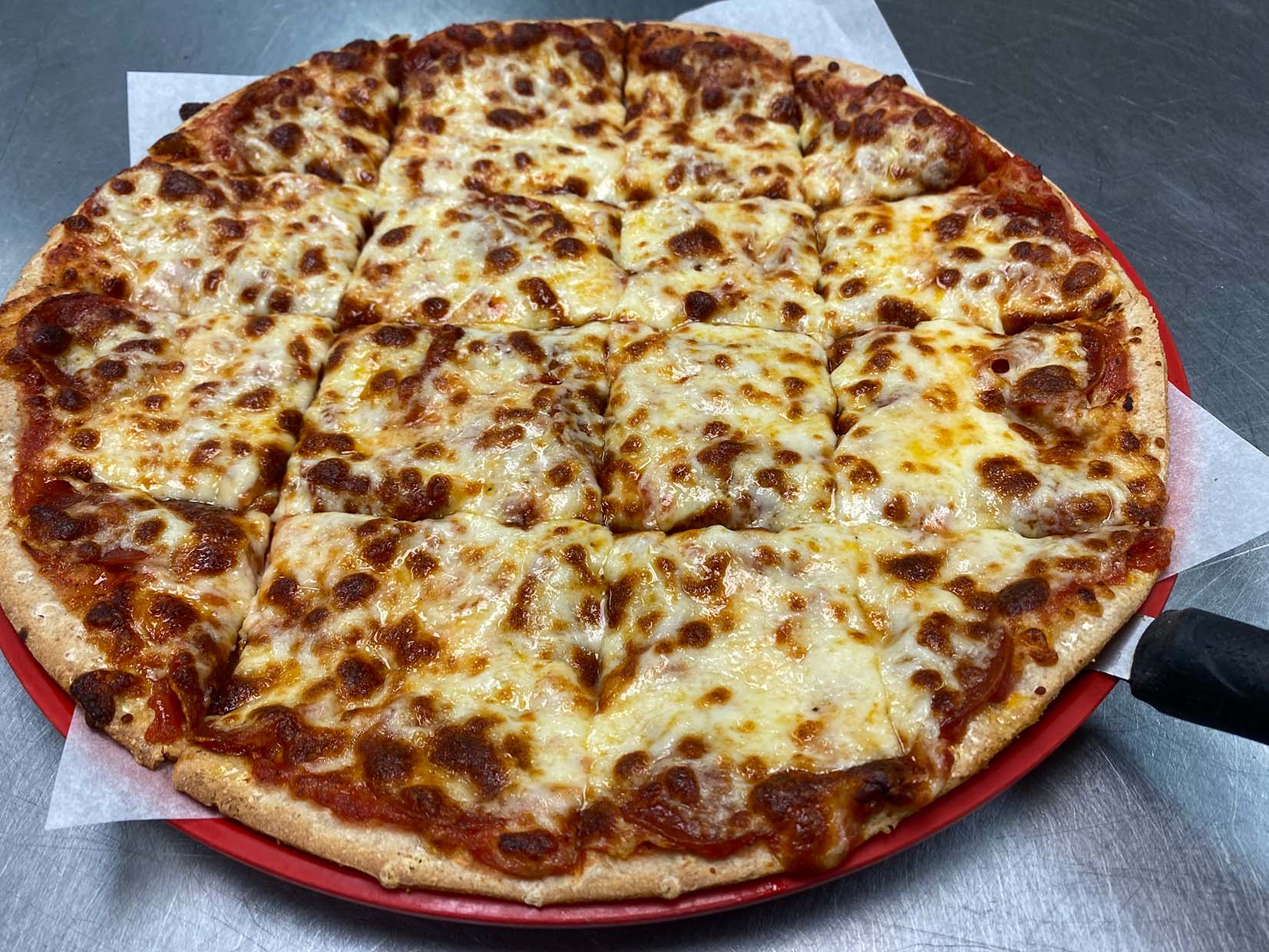 Whole pizza full of cheese — Rochester, MN — Zadeos Pizza