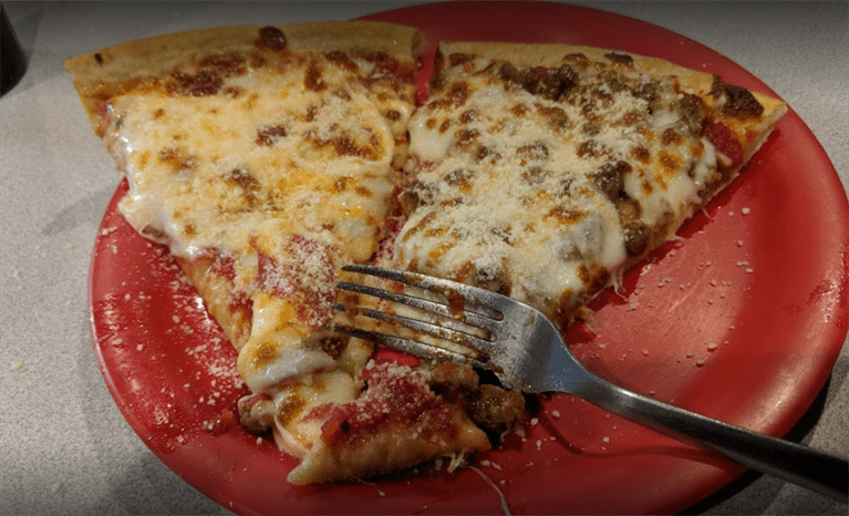 Two slices of pizza on red plate — Rochester, MN — Zadeos Pizza