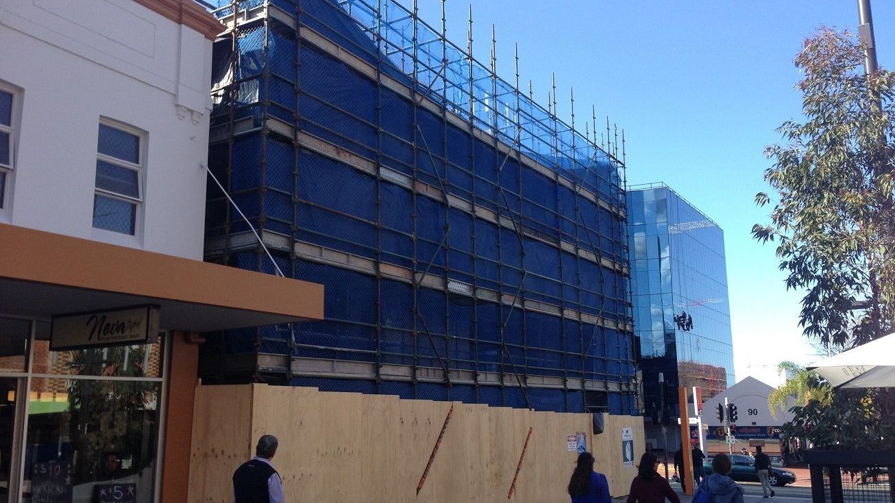 Commercial scaffold with A-Class hoarding for safe public access and protection during building work.