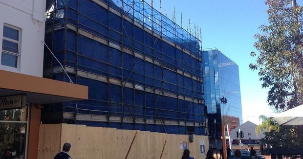 Commercial scaffold with A-Class hoarding for safe public access and protection during building work.