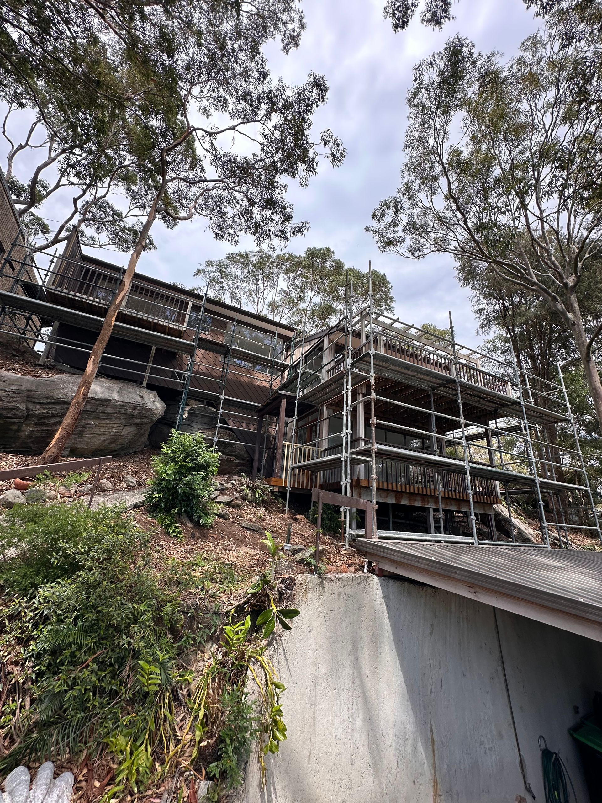 Scaffold system installed on a steep, sloping bushland property with limited site access for construction work.