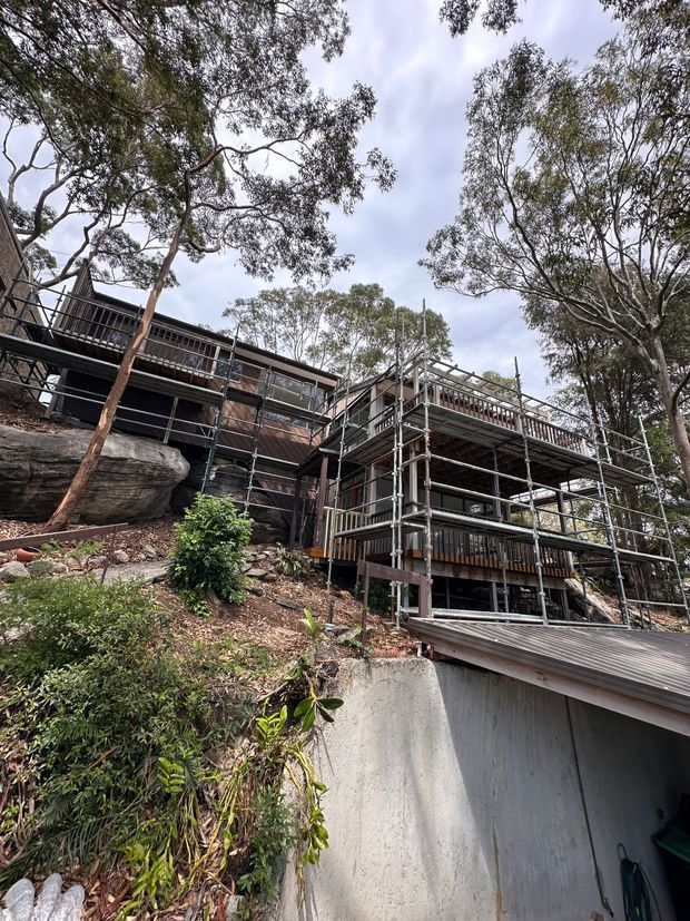 Scaffold system installed on a steep, sloping bushland property with limited site access for construction work.