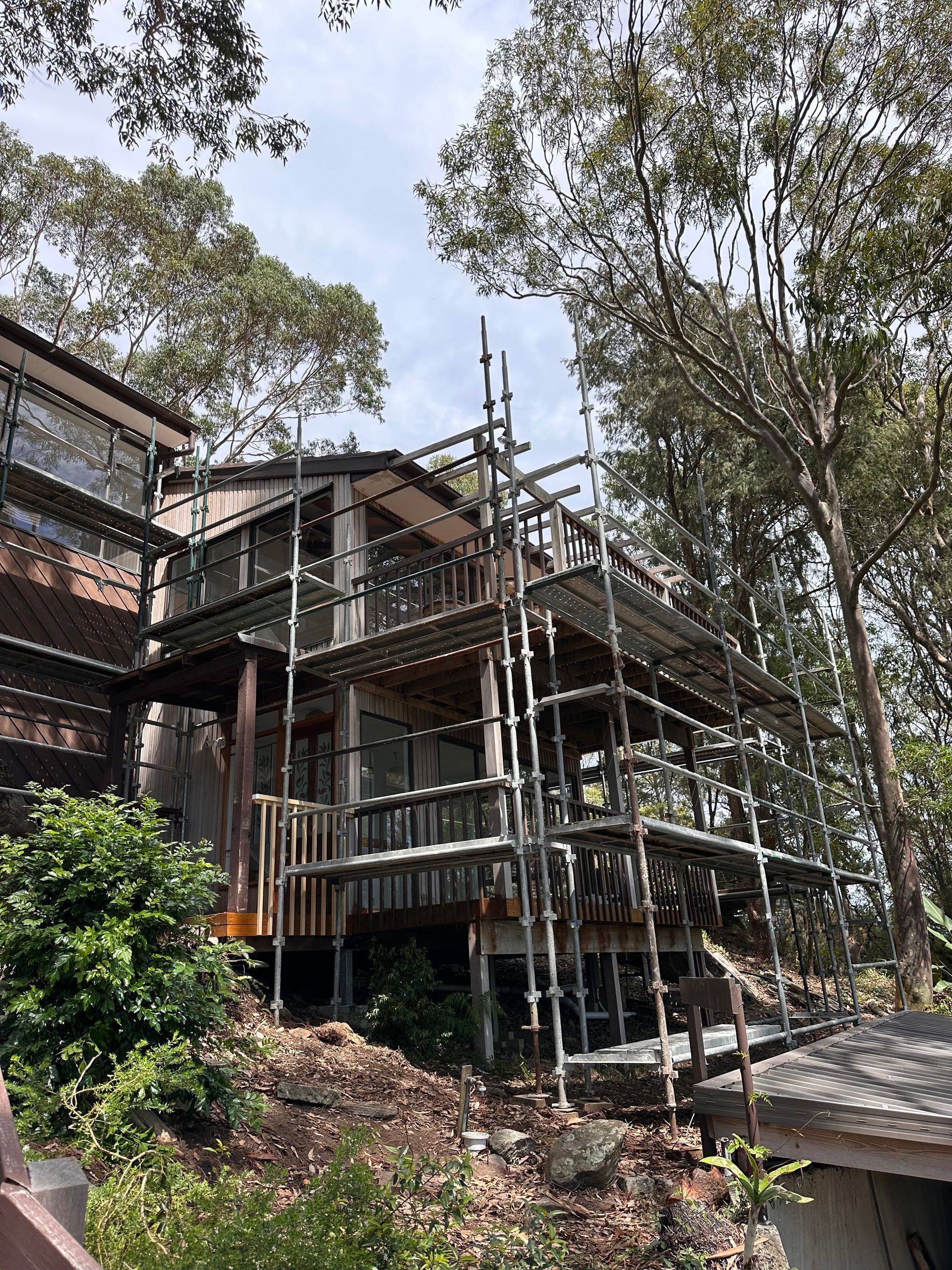 Scaffold installed in backyard for exterior renovation or painting of two-storey home.