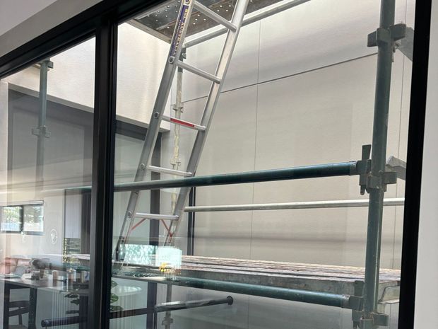 Internal scaffold installation inside a lift shaft with ladder access for construction or maintenance work