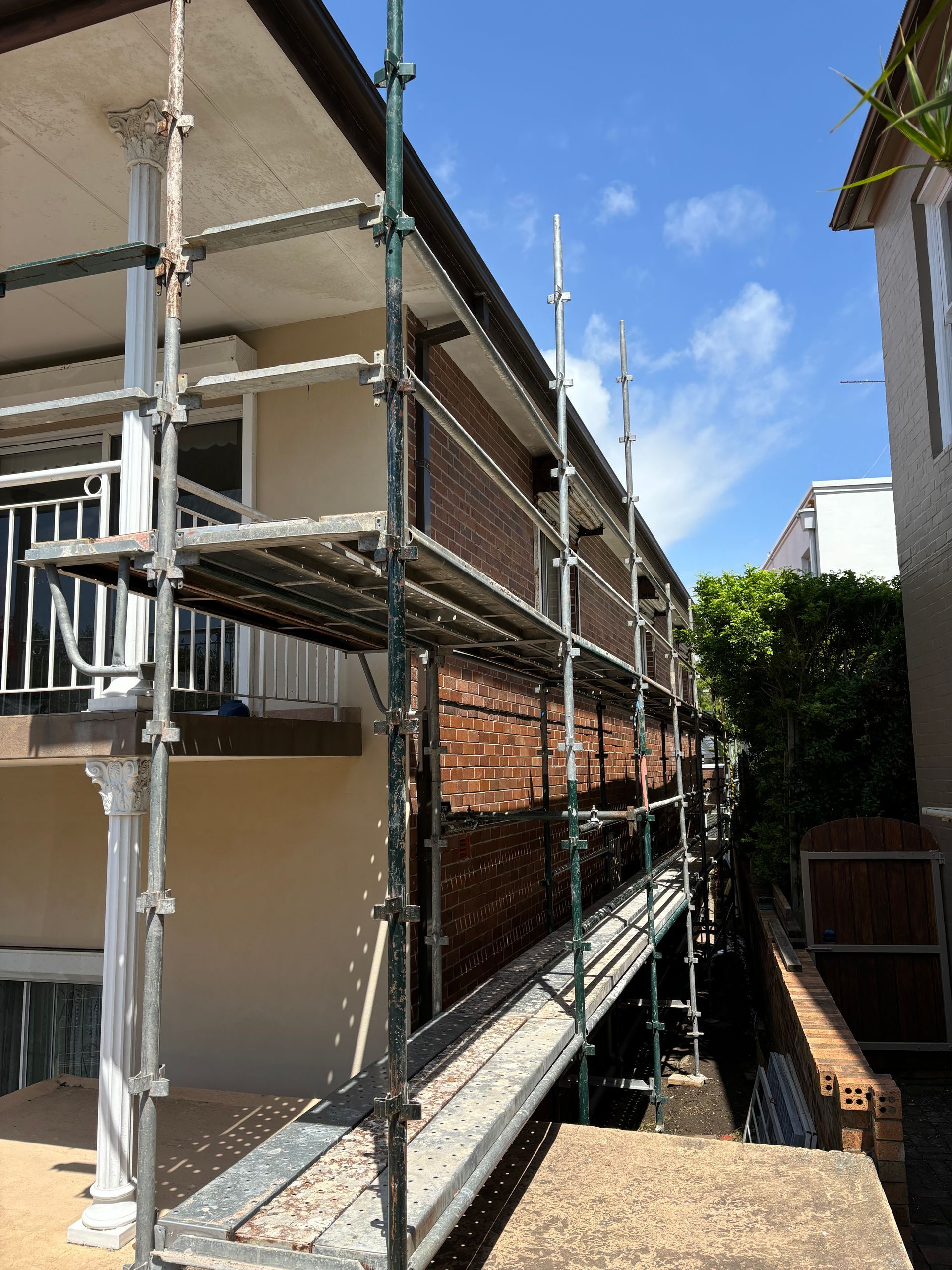 Residential side access scaffold installed for window and upper-level maintenance work