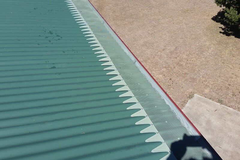 Plastic Guard Over Gutter on a Roof — Pressure Cleaning Services in Toowoomba, QLD