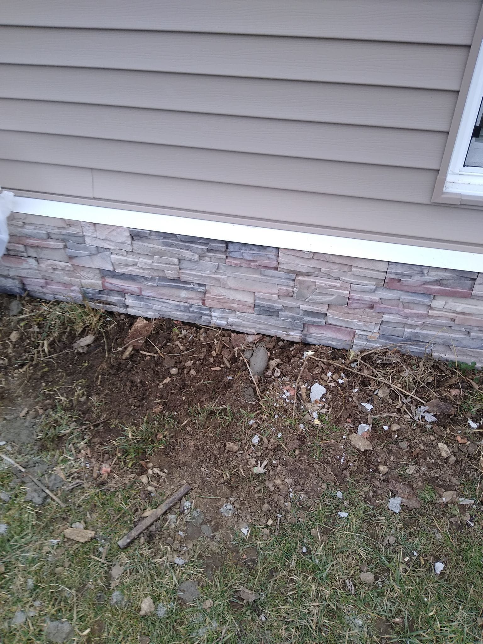 A house with a stone foundation and a window.