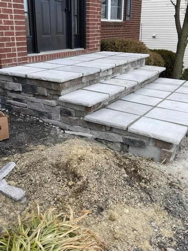 A set of steps leading up to a brick house.