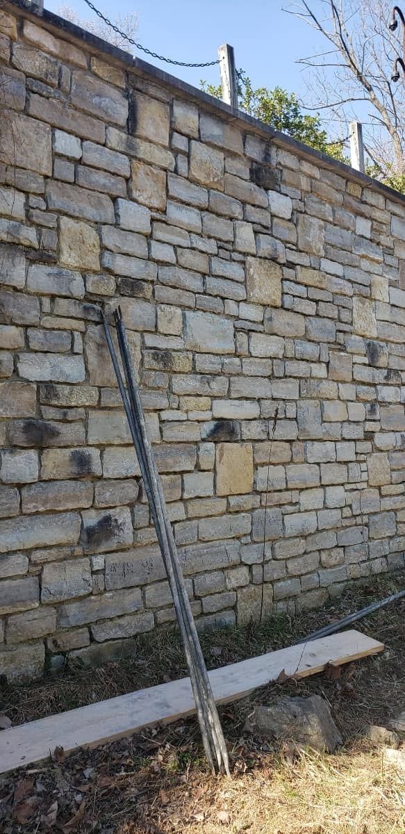 A brick wall with a chain attached to it.