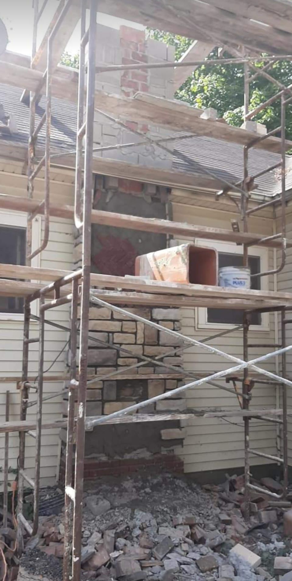 A house is being remodeled with scaffolding around it.