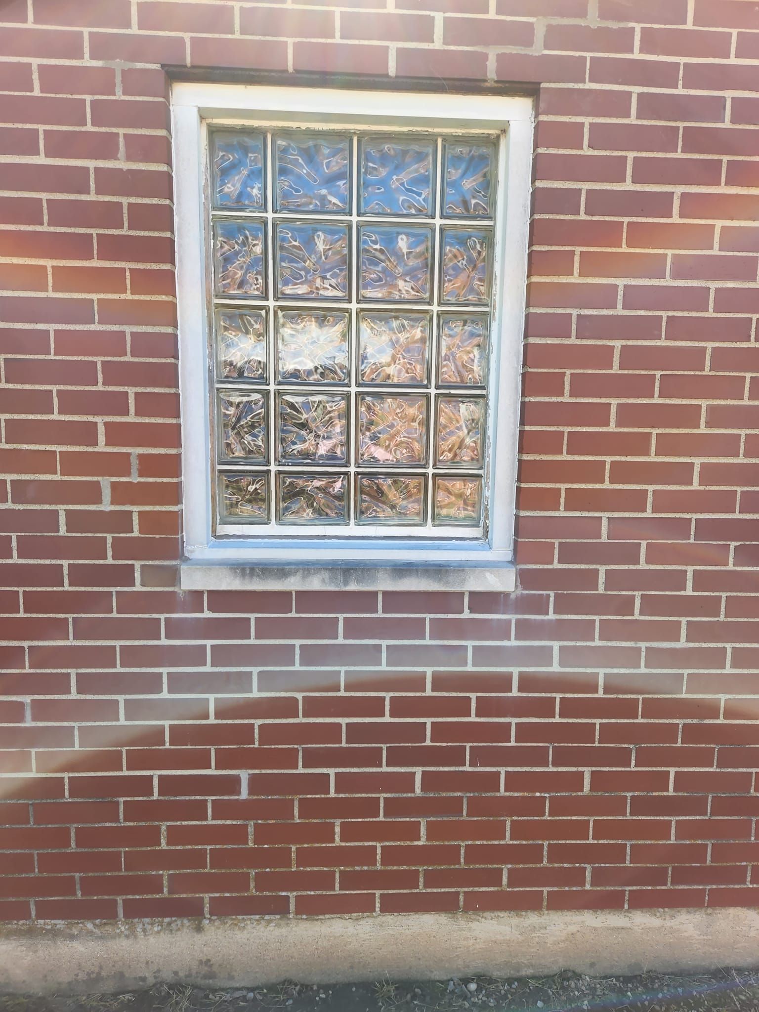 A brick wall with a window in it