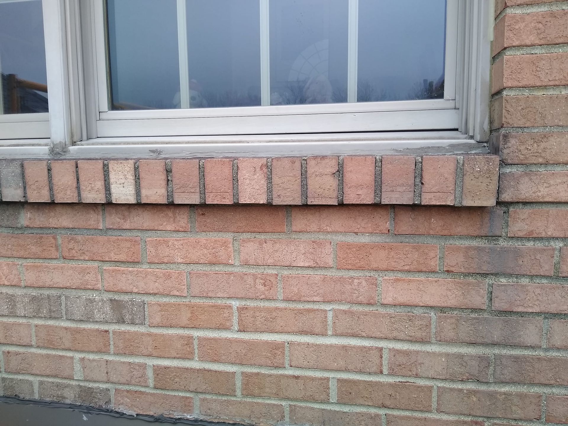 A brick wall with a window on it