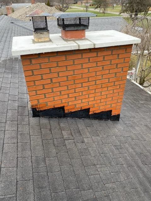 A brick chimney sitting on top of a roof