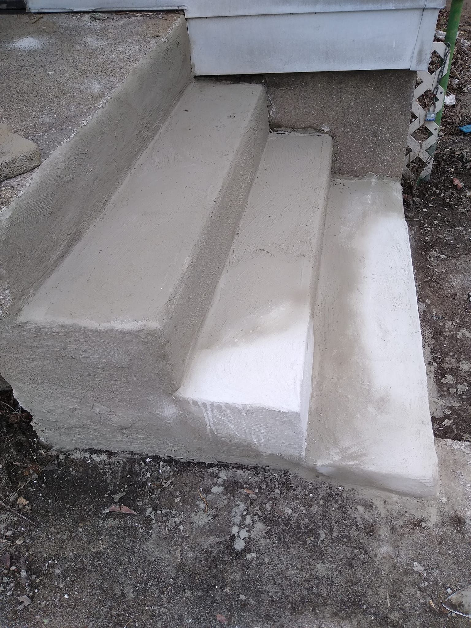 A set of concrete steps leading up to a house.