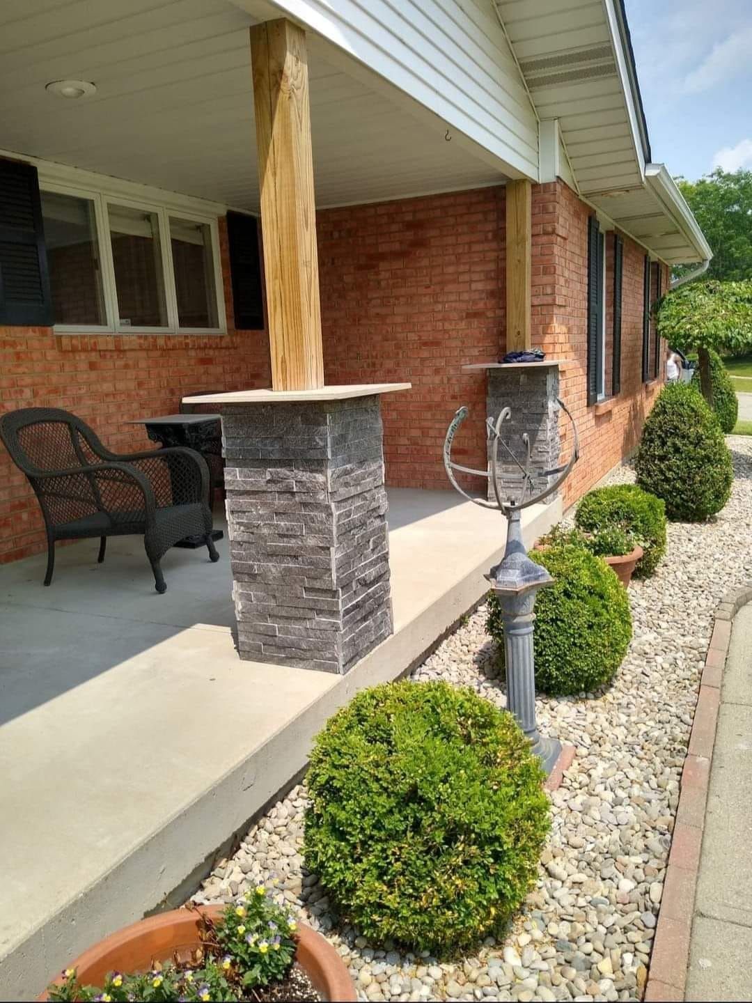 A brick house with a porch and a chair on it