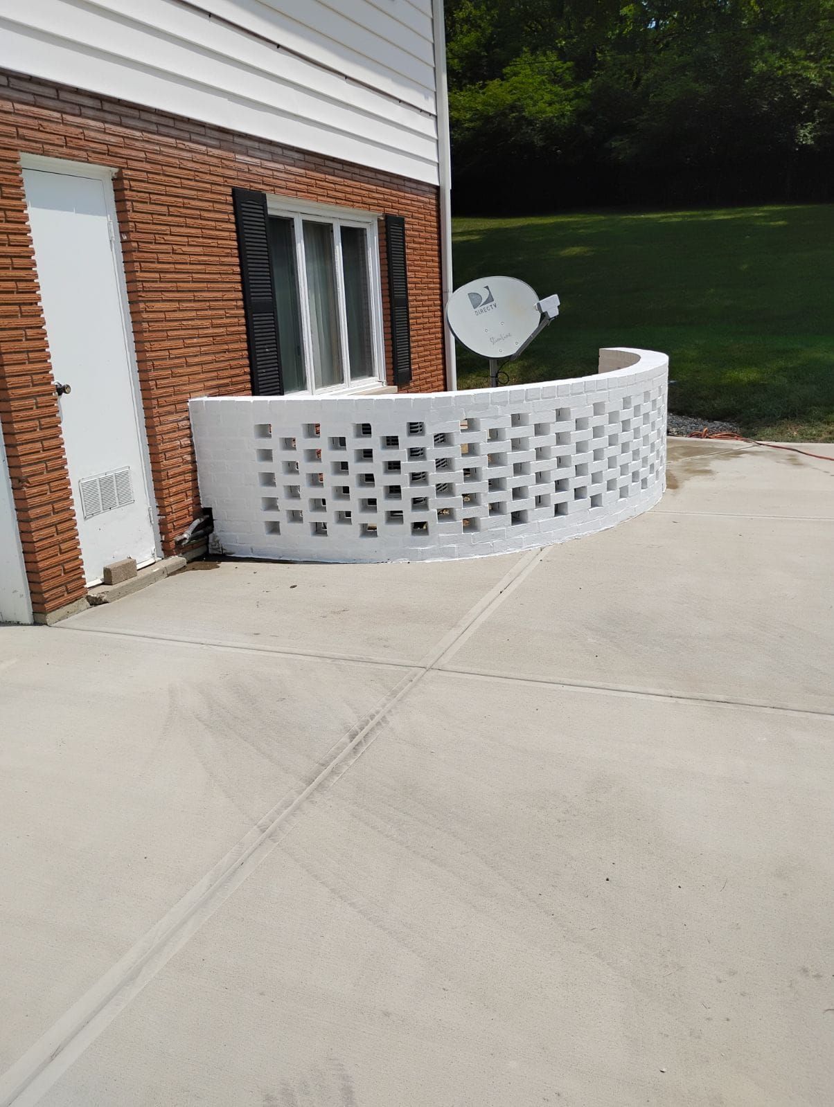 A brick house with a satellite dish on the side of it