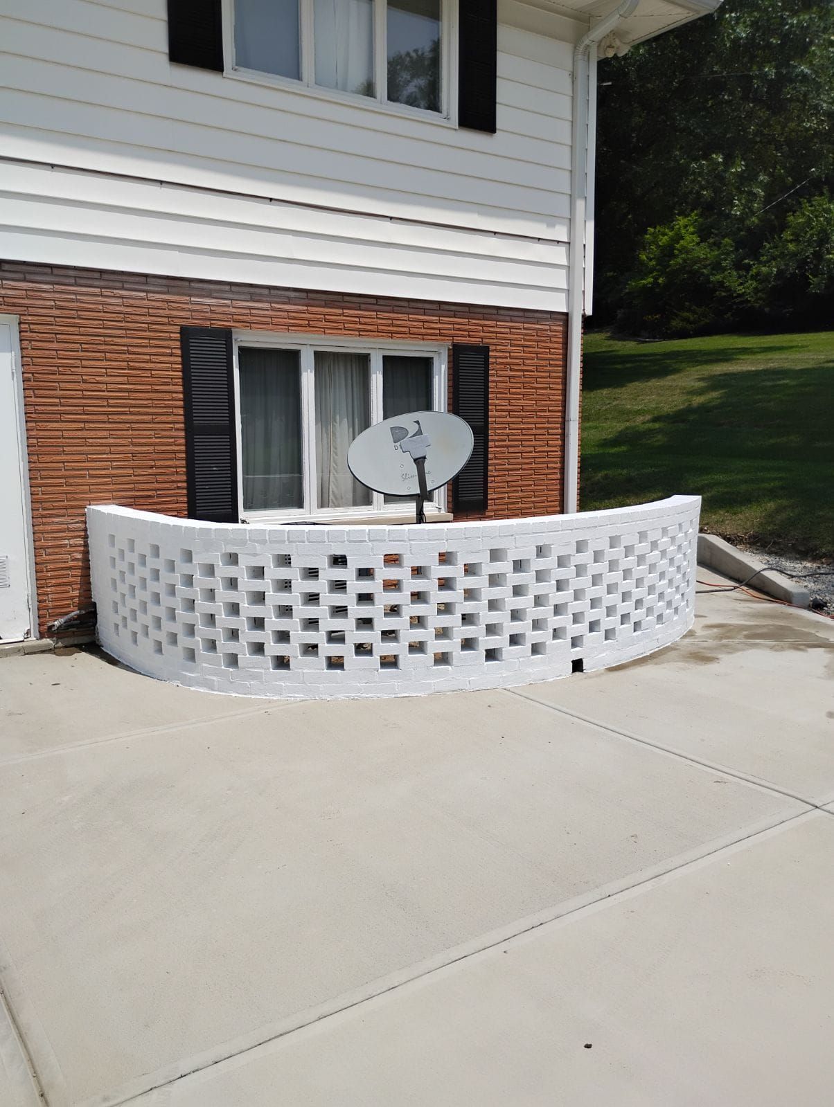 There is a satellite dish on the side of the house.