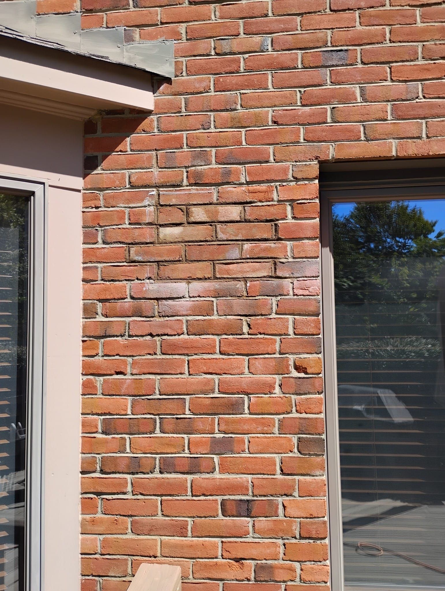 A close up of a brick wall with a window