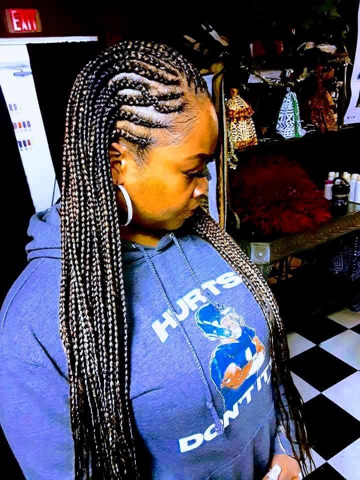 A woman wearing a blue hoodie with the word hurts on it