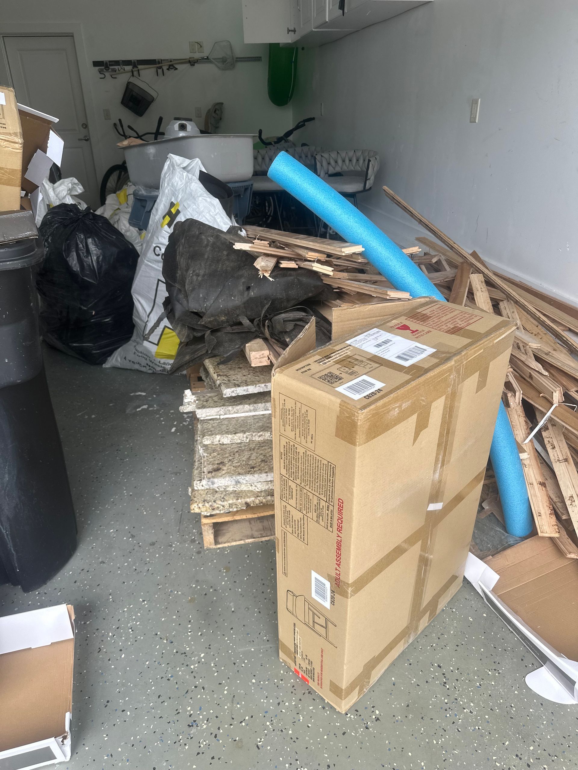 A pile of cardboard boxes and wood in a garage