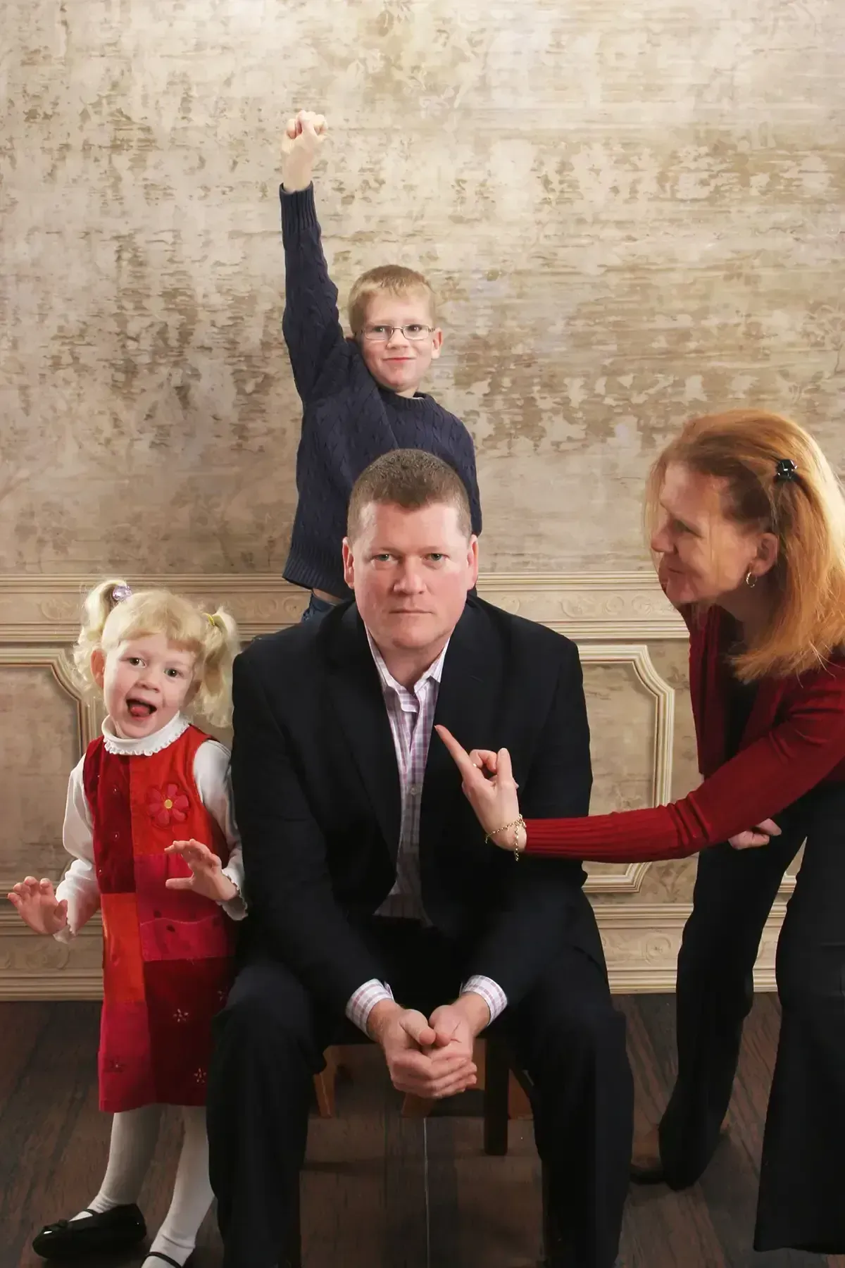 A family posing for a picture with a man sitting in the middle