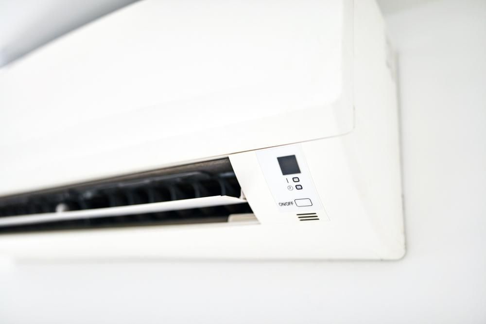 White Air Conditioning Unit Mounted on a White Wall — Active Airconz in Katherine, NT