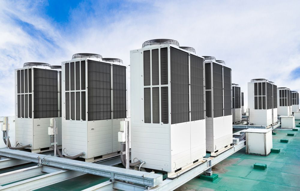 Row of Large Rooftop Hvac Units Against a Blue Sky — Active Airconz in Katherine, NT