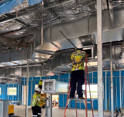 Two Construction Workers Wearing Hard Hats and High-visibility Clothing — Active Airconz in Winnellie, NT