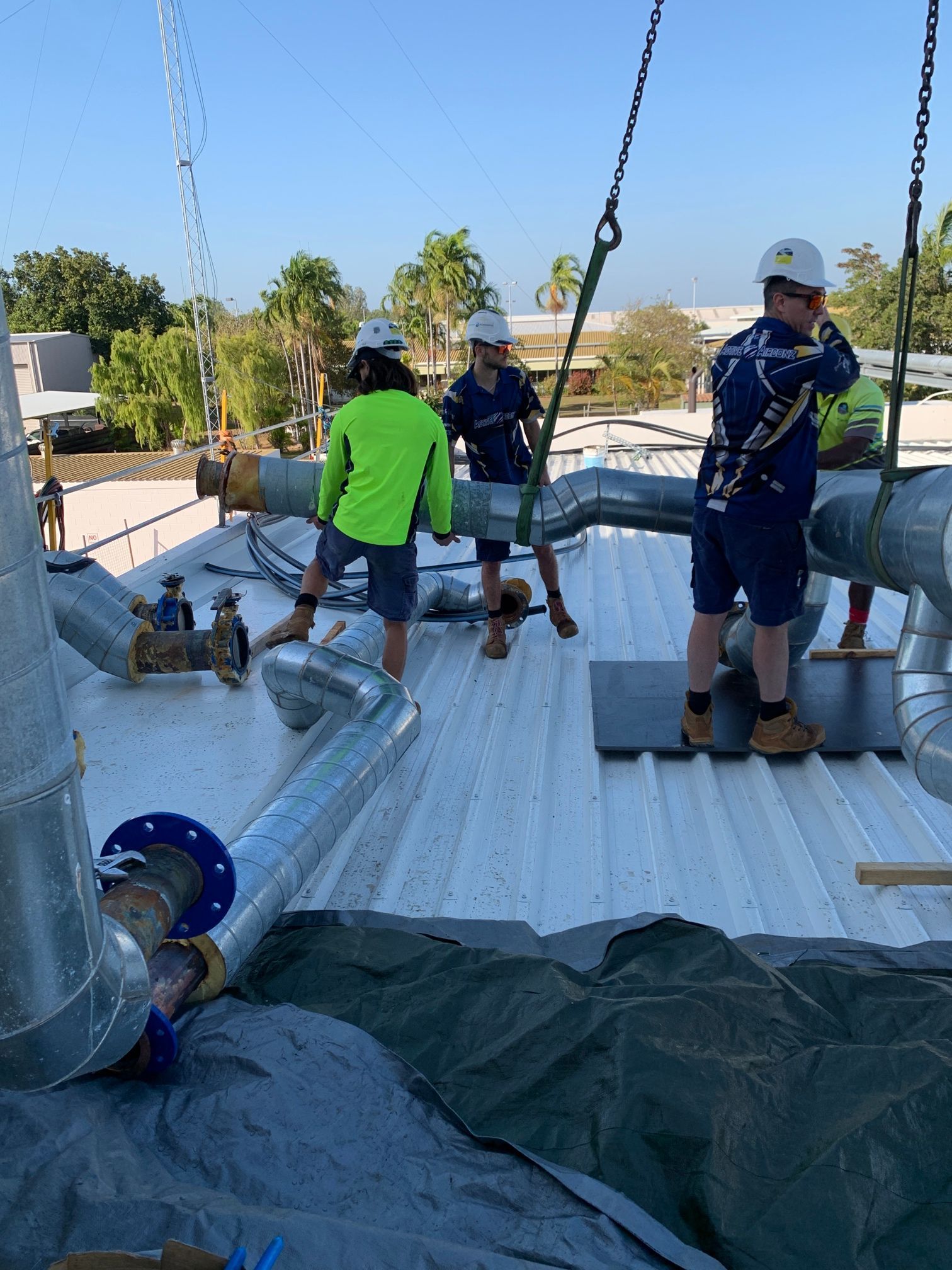 Four Construction Workers Wearing Hard Hats and High-visibility Clothing — Active Airconz in Winnellie, NT