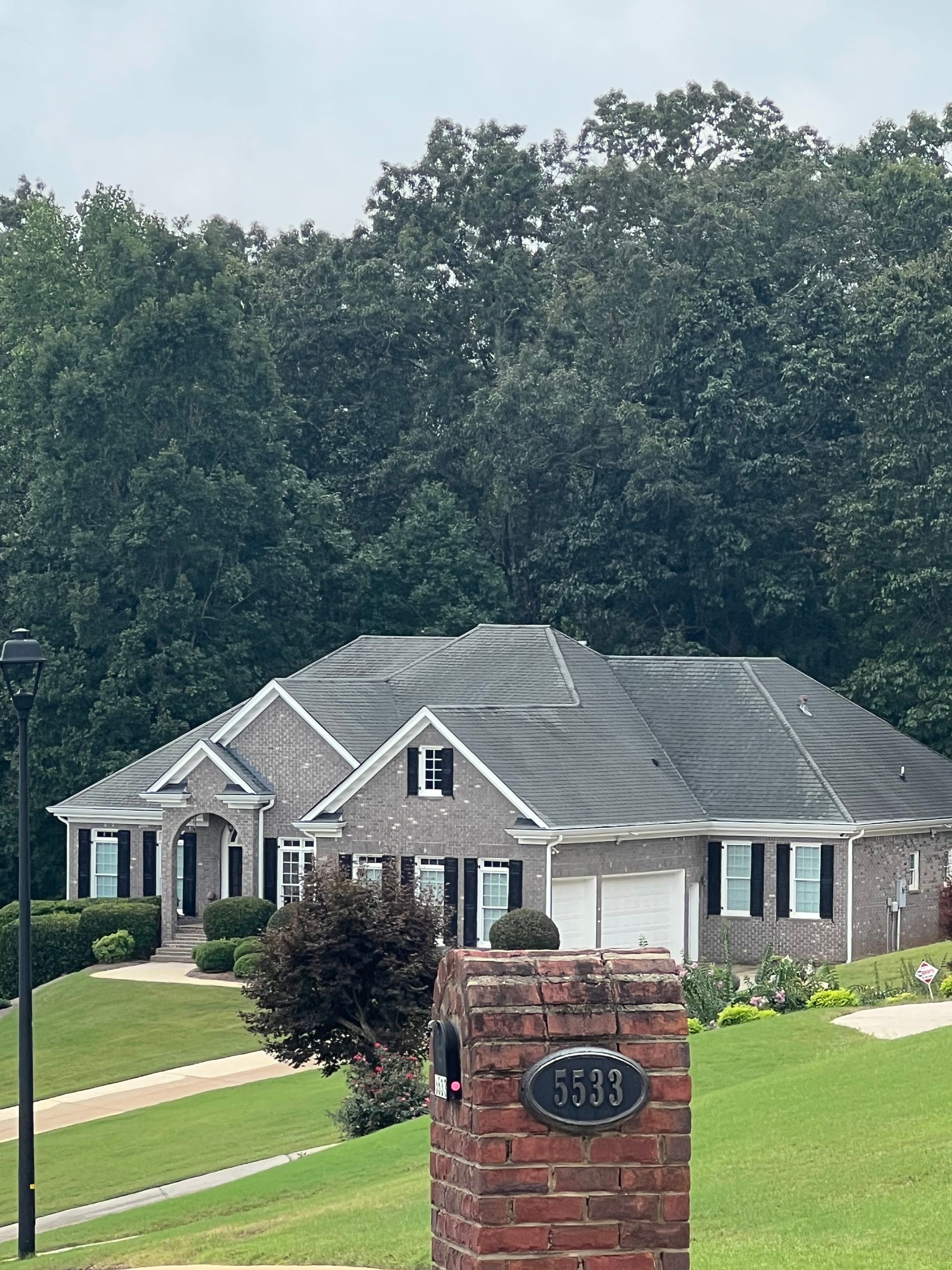 A large house with a brick chimney in front of it