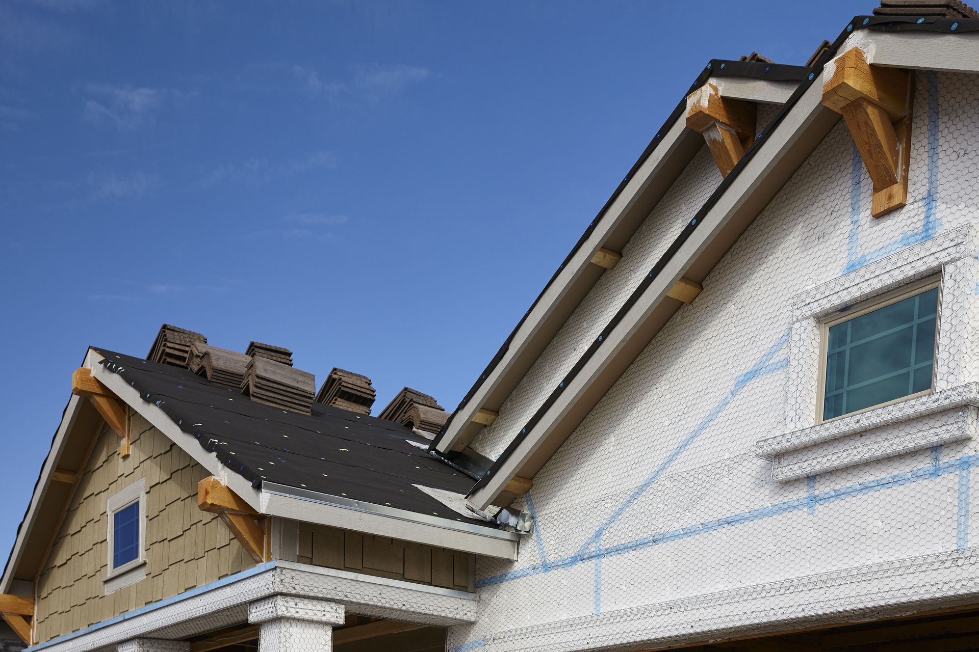 A house under construction with a blue sky in the background
