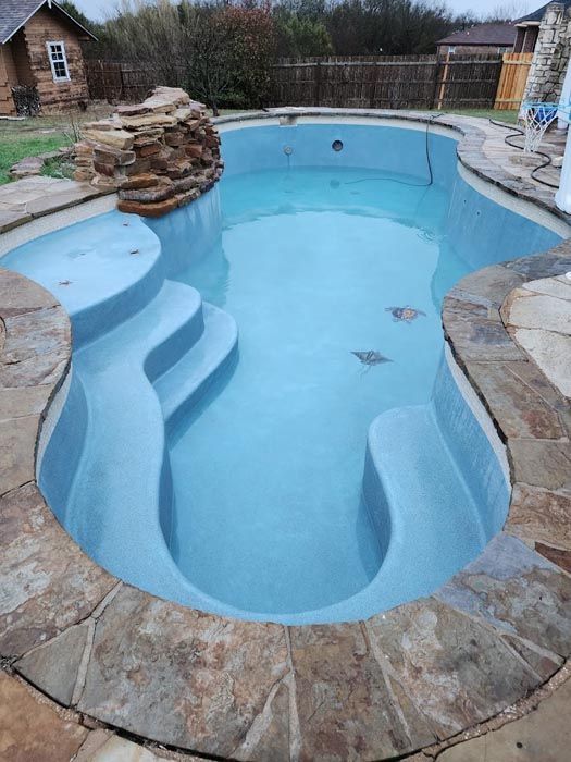 A Large Swimming Pool with Stairs Leading up To It