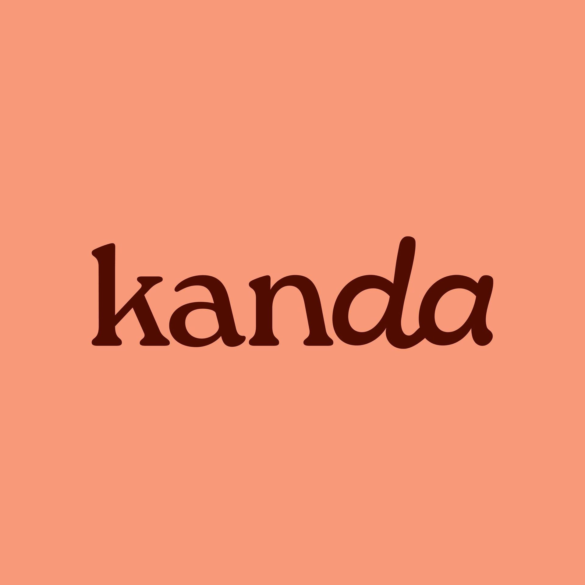 "kanda" in dark brown script on a coral-colored background.