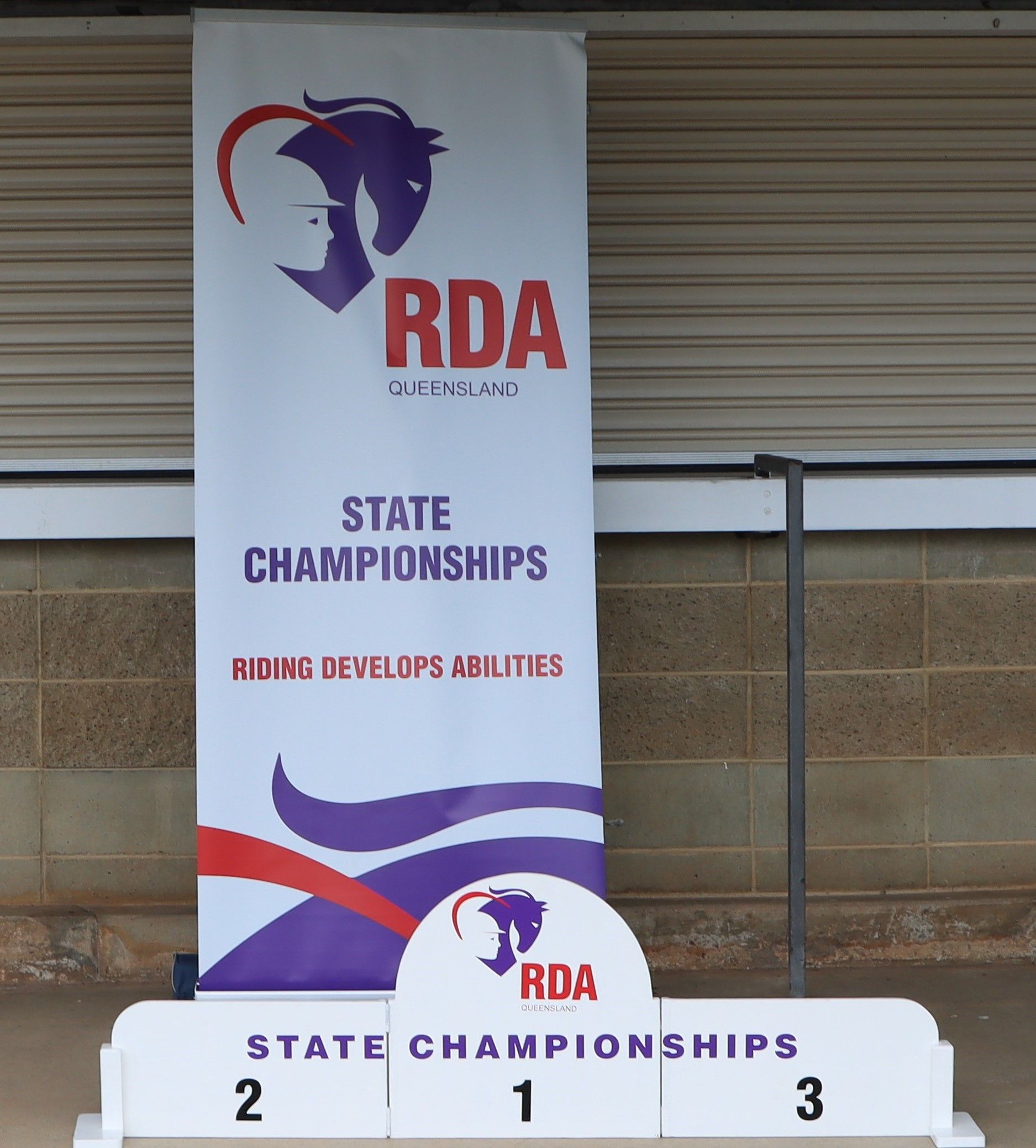 Banner for RDA State Championships with a podium numbered 1, 2, and 3.