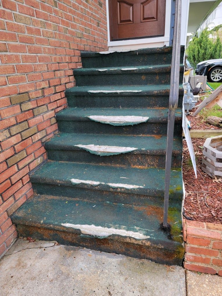 a set of stairs leading up to a brick building .