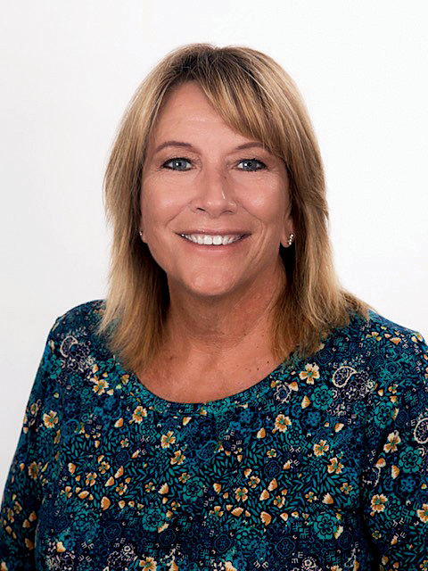A woman with curly hair is holding a green briefcase.
