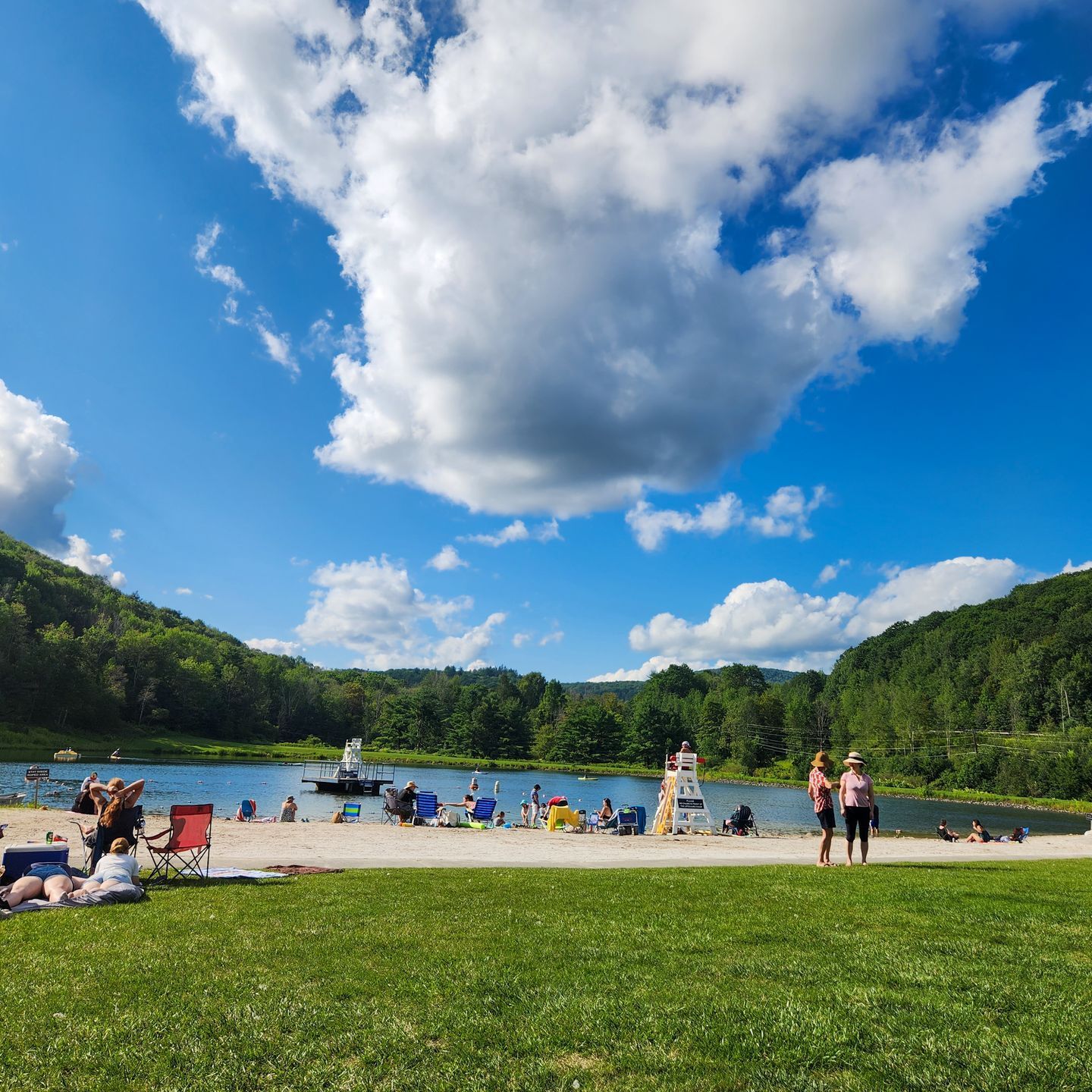 People enjoying Belleayre beach on a beautiful summer day.