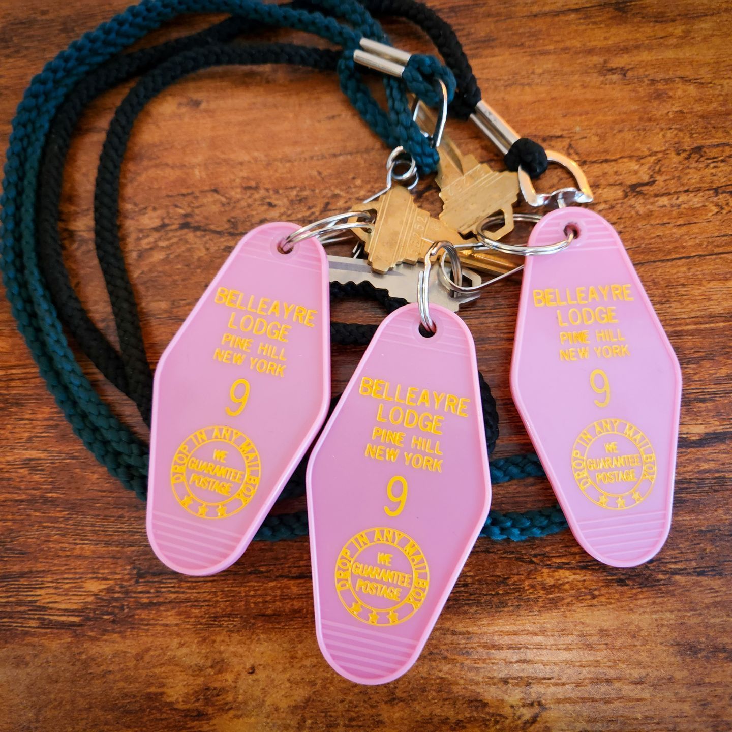 Closeup of Belleayre Lodge branded keychains, showing the address in Pine Hill, NY