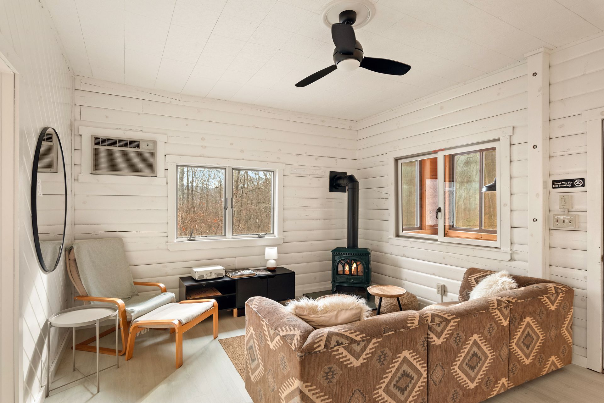 Interior of a Belleayre Lodge Cabin 6A, showing cozy living space with chairs, sofas, and cabins. Catskills window view