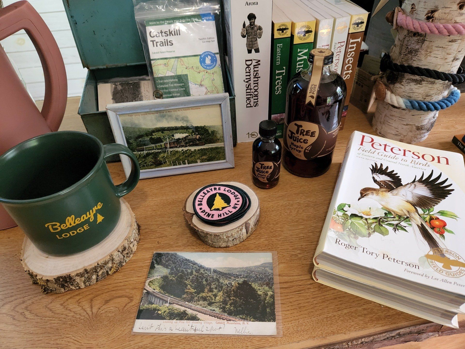 Close up of the Belleayre Lodge Shop in Pine Hill, NY, featuring branded mugs, coasters, and books