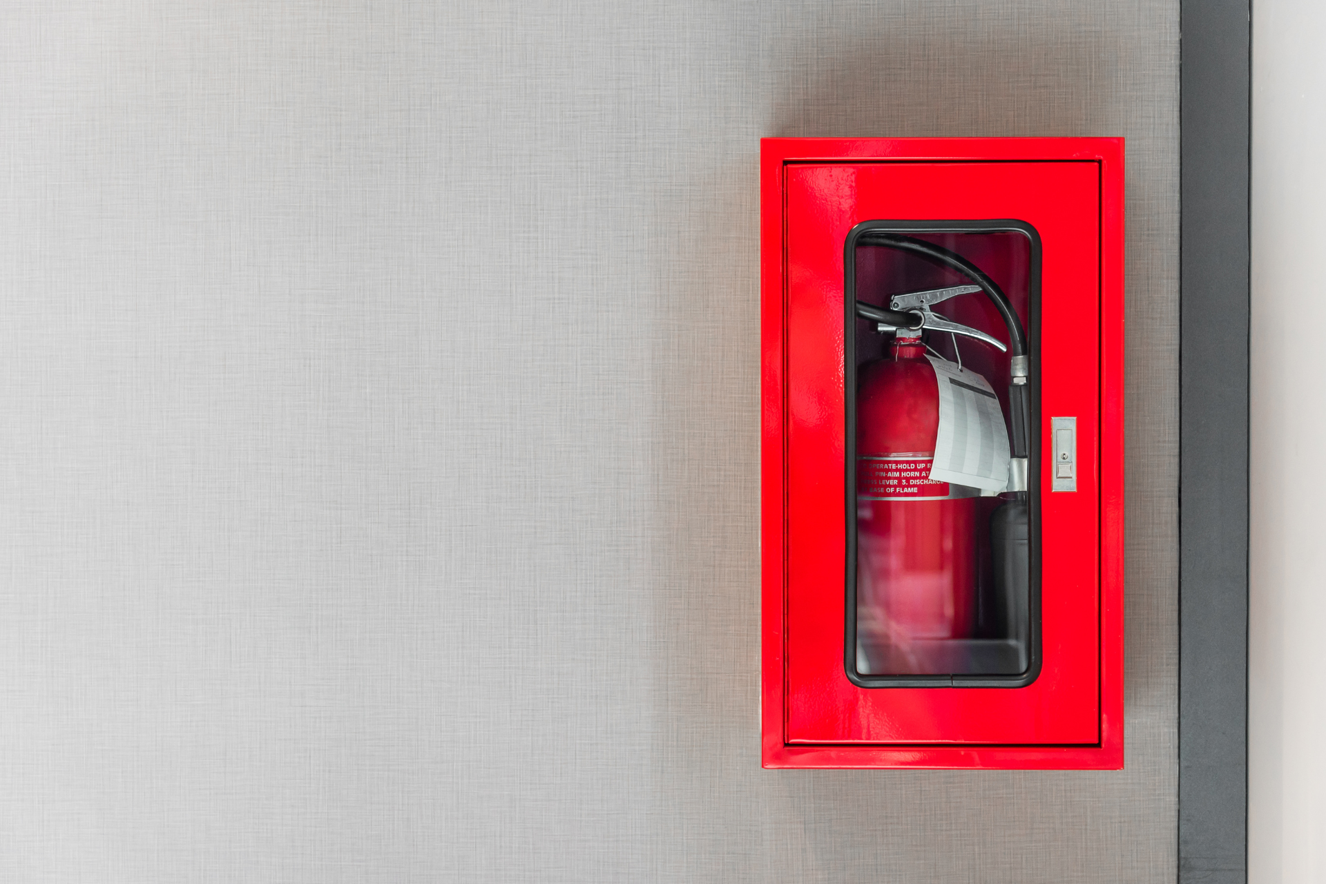 A room filled with lots of red pipes and a pump.