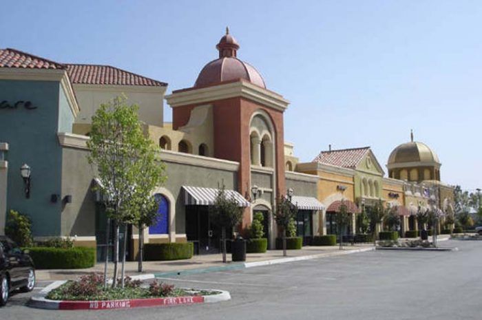 Exterior of retail and outdoor mall area with multi-colored stucco sides.