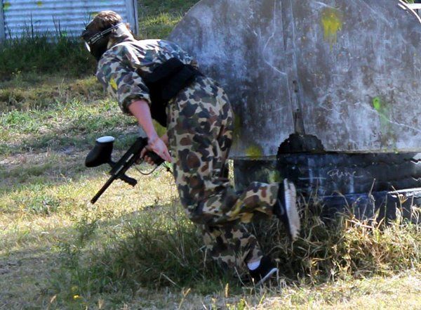 paintball player looking around corner